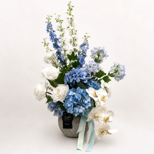 Artificial Flower Arrangement Aspen with blue hydrangeas, Phalaenopsis orchids, Real Touch roses and delphiniums in a textured stone vase by Desflora